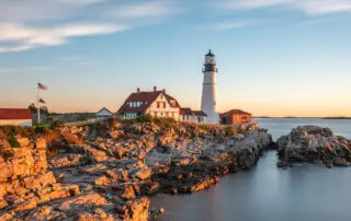 a white lighthouse on the Maine coast