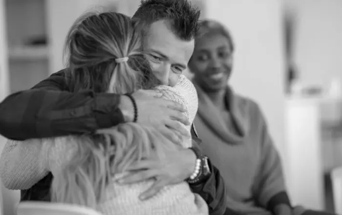 a woman hugging a man